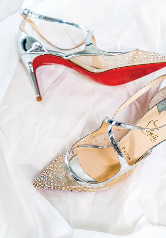 Pair of restored crystal-embellished designer heels with a red Louboutin sole.